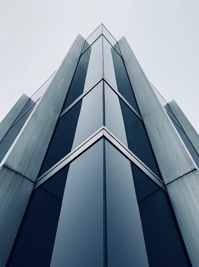 Low-angle shot of a sleek, modern skyscraper in Zürich, showcasing its glass and steel exterior.